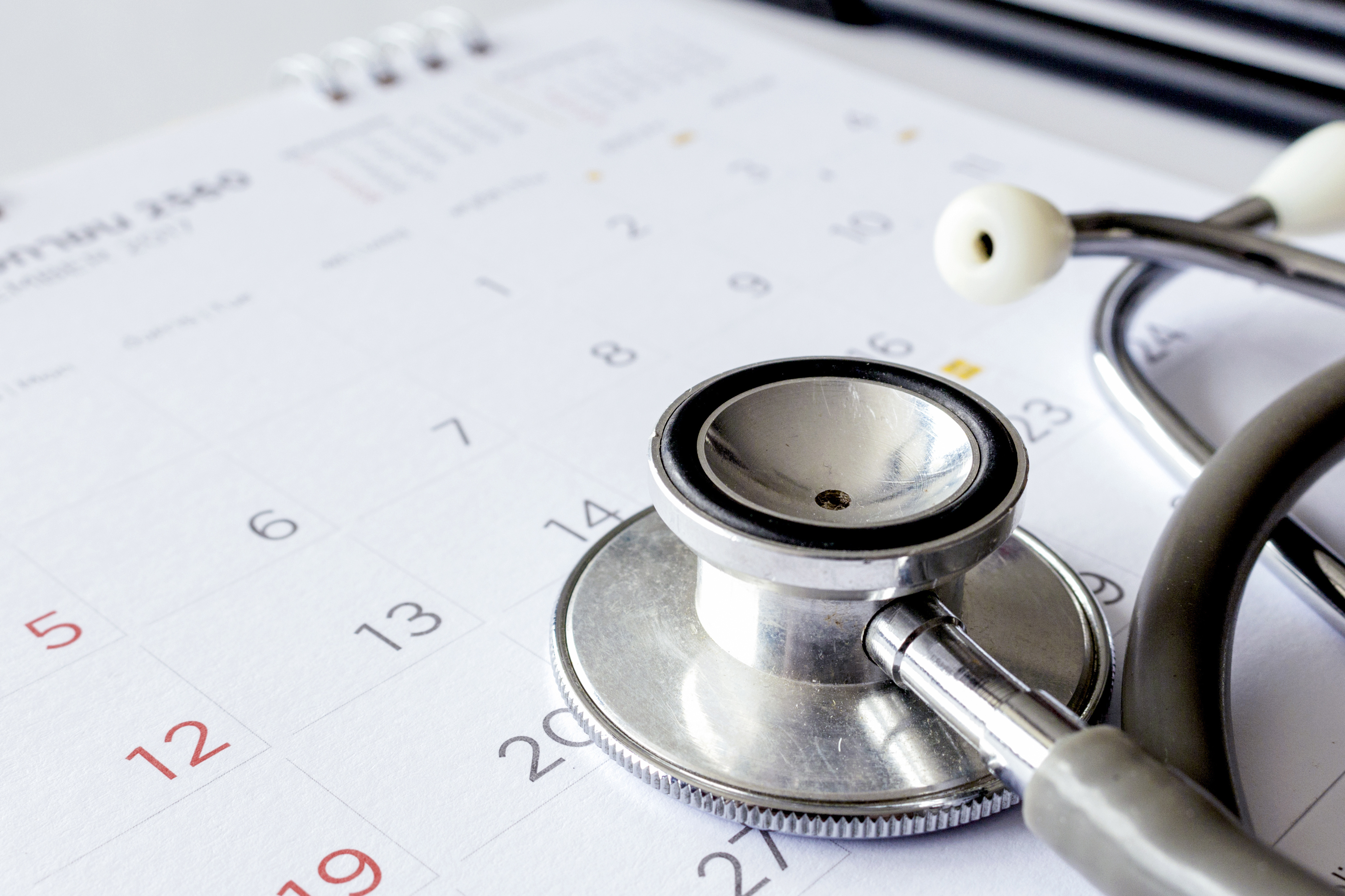 stethoscope on top of calendar